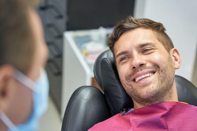 man smiling at dentist