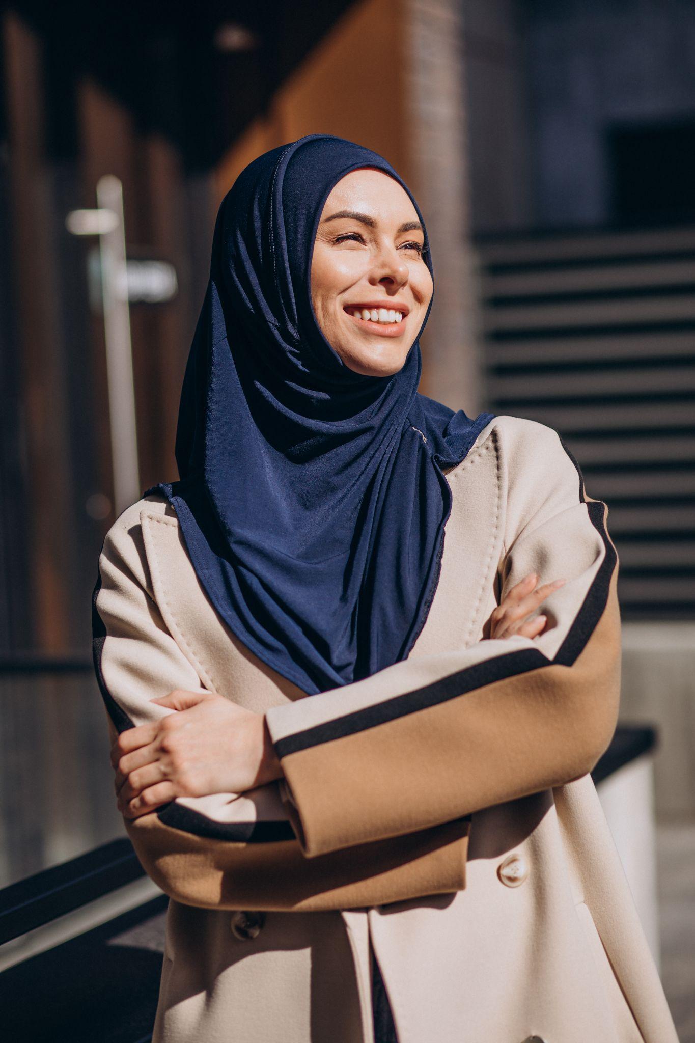 woman smiling towards right hand side wearing headscarf