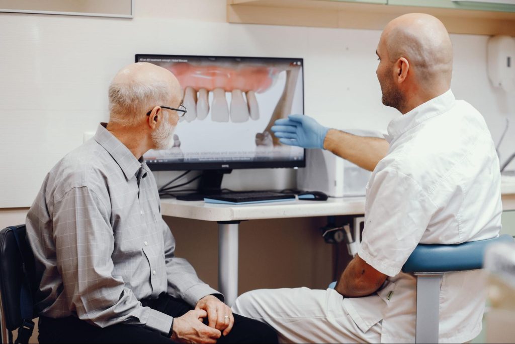 dentist and patient examining tooth structure